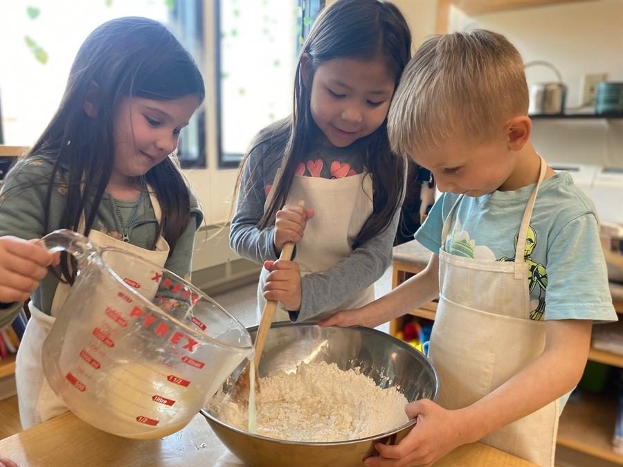 Children preparing food together during a practical life activity