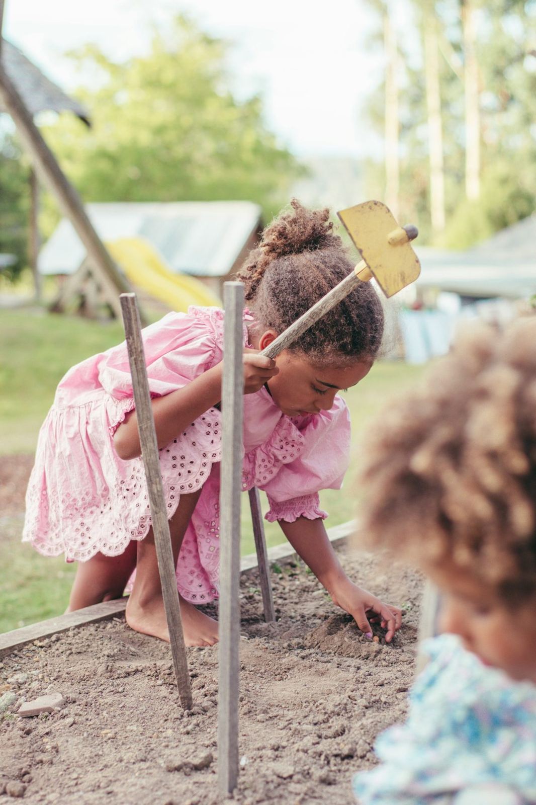 A child tending a garden bed